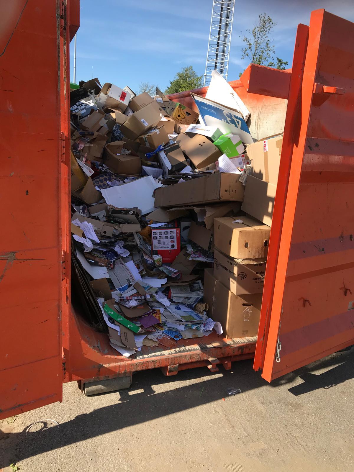 Een vuilcontainer met oud papier